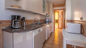 A compact kitchen with a coffee maker, sink, and microwave. - Apartamento Vanessa in Costa Adeje (Adeje)