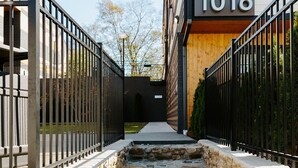 A stone staircase leading to a modern building with the number 1016.
