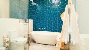 A modern bathroom with a freestanding bathtub, a glass shower enclosure, and a wooden vanity. - Aquabelle Seven - Couples Retreat That Will Delight (Melbourne)