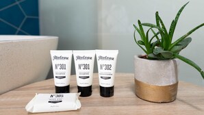 Three bottles of Biolage hair care products and a small potted plant on a wooden surface. - Aquabelle Seven - Couples Retreat That Will Delight (Melbourne)