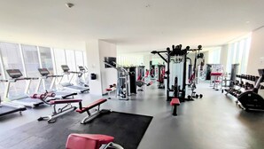 A modern gym with treadmills, weight machines, and free weights. - Luxurious High-rise HS Wifi Amazing City Views (Mexico City)