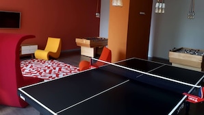 A room with a ping pong table, two foosball tables, a TV, and a sofa. - Alluring Views Luxuriously Appointed in Polanco (Mexico City)
