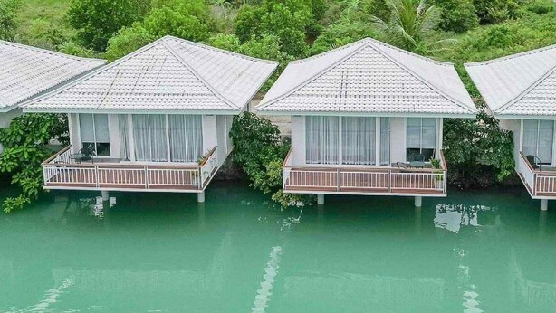 Overwater bungalows with balconies, connected by walkways over water. - The wide view resort cafe (Thep Krasattri)