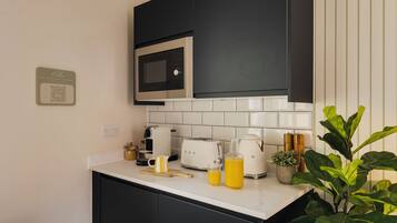 Fridge, coffee/tea maker, toaster, dining tables