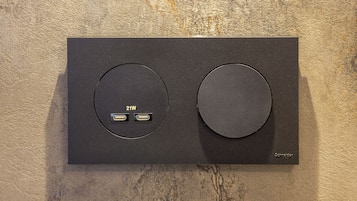 A black control panel with two circular buttons and two USB ports labeled '21W'.