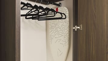 A wardrobe with a hanging iron, a white towel, and a Yale lock.