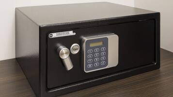 A black safe with a keypad and a combination lock.