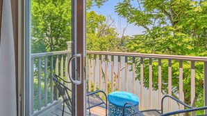 A balcony with a view of trees and a clear sky. - Music City Living - 2BR/2BA Riverfront Paradise with FREE PARKING (Nashville)