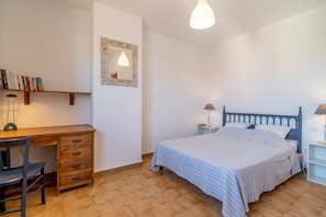 A bedroom with a bed, bedside tables, a desk, a chair, a mirror, and a bookshelf. - Holiday Home 'Maison T3' with Terrace and Air Conditioning (Port-la-Nouvelle)