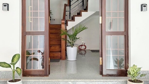 A wooden door with glass panels leading to a staircase. - Peaceful 2BHK Retreat | Near Forest Reserve (Kathmandu)