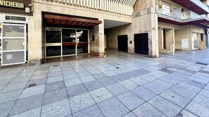 A building with a tiled ground floor and a covered entrance.