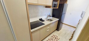 Fridge, microwave, coffee/tea maker, cookware/dishes/utensils