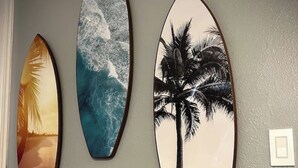 Three surfboards mounted on a wall.