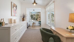 A modern, well-lit room with a desk, chair, and a view through a window. - Inchcolm – Your Quintessential Blue Mountains Getaway (Leura)