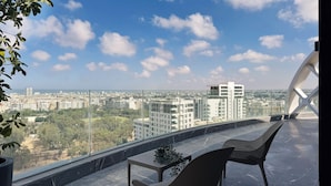 A balcony with a clear view of a cityscape, including modern buildings and a distant body of water. - Hotel Soho Boutique Casablanca (Casablanca)