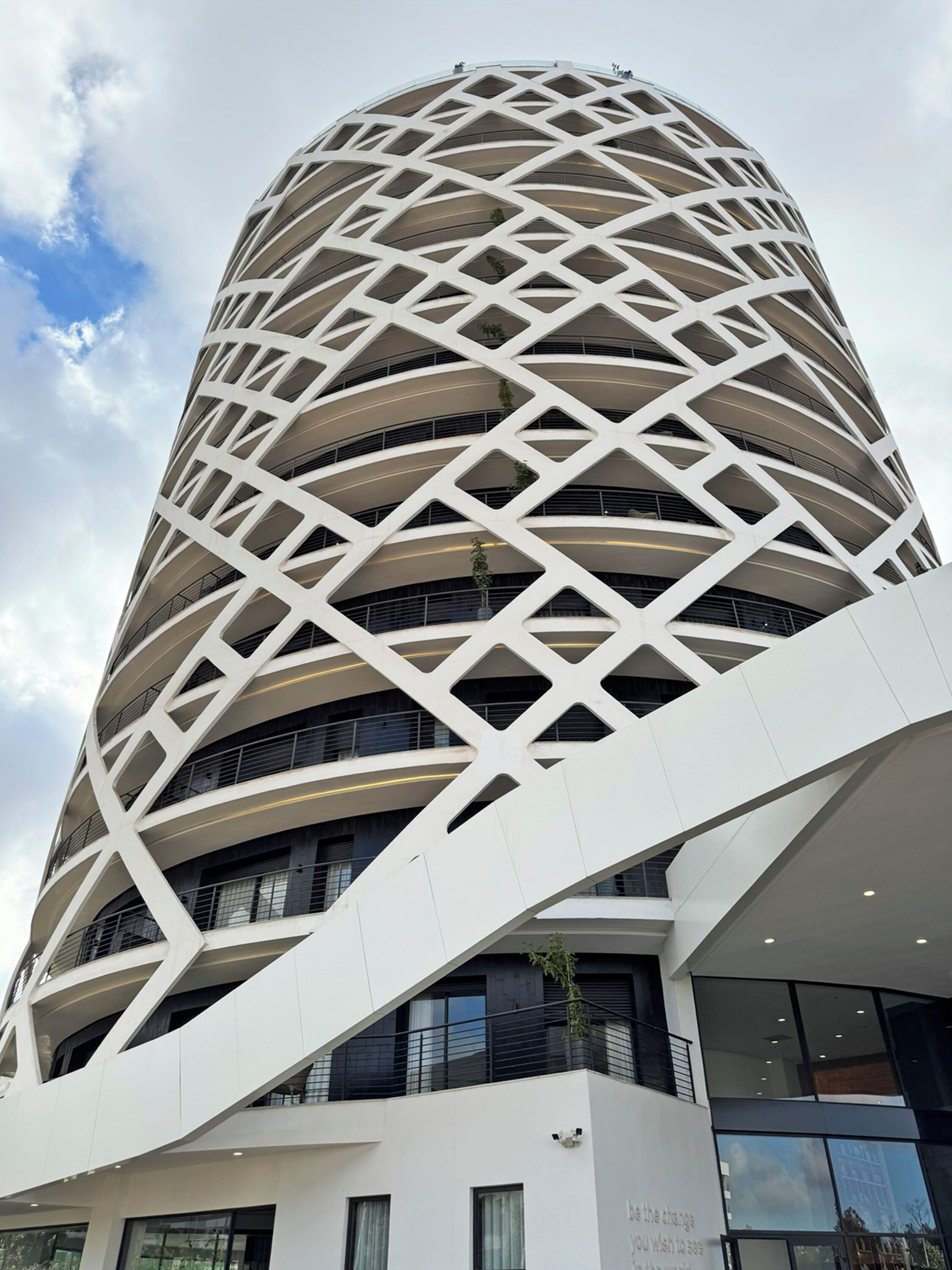 A modern building with a distinctive geometric facade and multiple balconies.