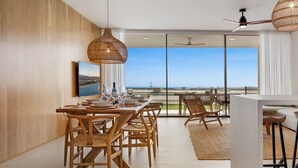 A modern dining area with a view of the sea, featuring wooden furniture and woven pendant lights. - Valley | Sea view - pool - terrace (Fuengirola)