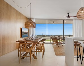 A modern dining area with a view of the sea, featuring wooden furniture and woven pendant lights. - Valley | Sea view - pool - terrace (Fuengirola)