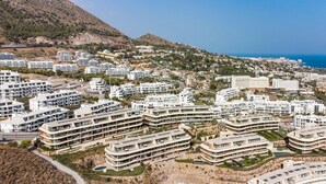 A coastal residential area with modern multi-story buildings, a clear view of the sea, and a hilly backdrop. - Valley | Sea view - pool - terrace (Fuengirola)