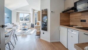 A modern kitchen with white cabinets, a built-in microwave, and a dishwasher. - 50m from resort center, 6th floor, view panoramic/resort, tv, 38m², Avoriaz (Avoriaz)