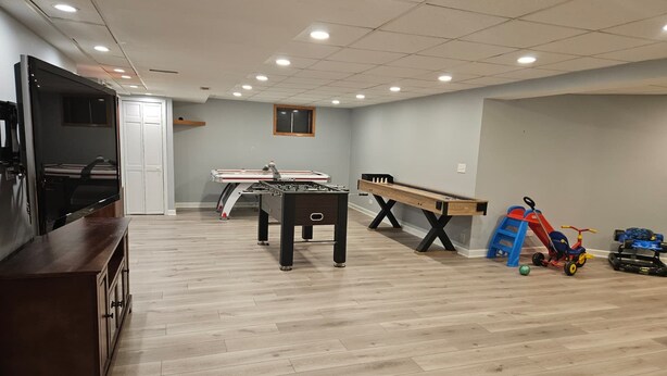 A spacious room with a pool table, foosball table, and a ping pong table. - Fun 5BR 4.5BA, Pool, Hot Tub, Game Rm, Near O’Hare (Wood Dale)