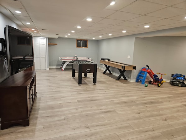 A spacious room with a pool table, foosball table, and a ping pong table. - Fun 5BR 4.5BA, Pool, Hot Tub, Game Rm, Near O’Hare (Wood Dale)