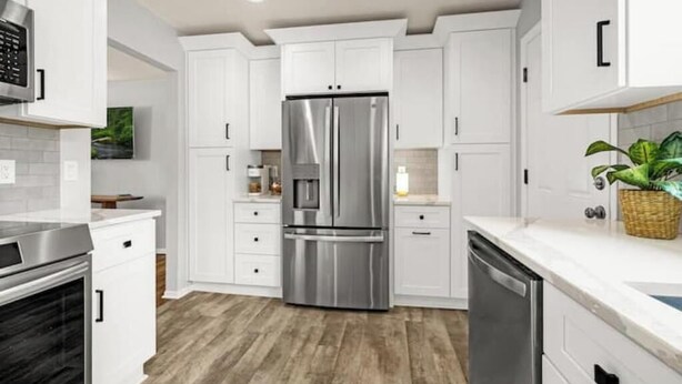 A modern kitchen with white cabinets, stainless steel appliances, and a wooden floor. - New Adventure Cottage w/ Mountain Views Near Garden of the God's and much more! (Colorado Springs)