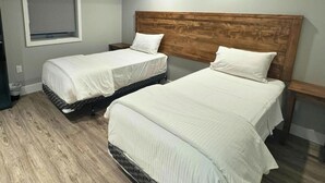 Two single beds with wooden headboards in a room with a wooden floor. - Newly Built Luxury Chalet Indoor Pool Ski Lift (The Blue Mountains)