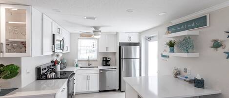 Fridge, dishwasher, coffee/tea maker, cookware/dishes/utensils