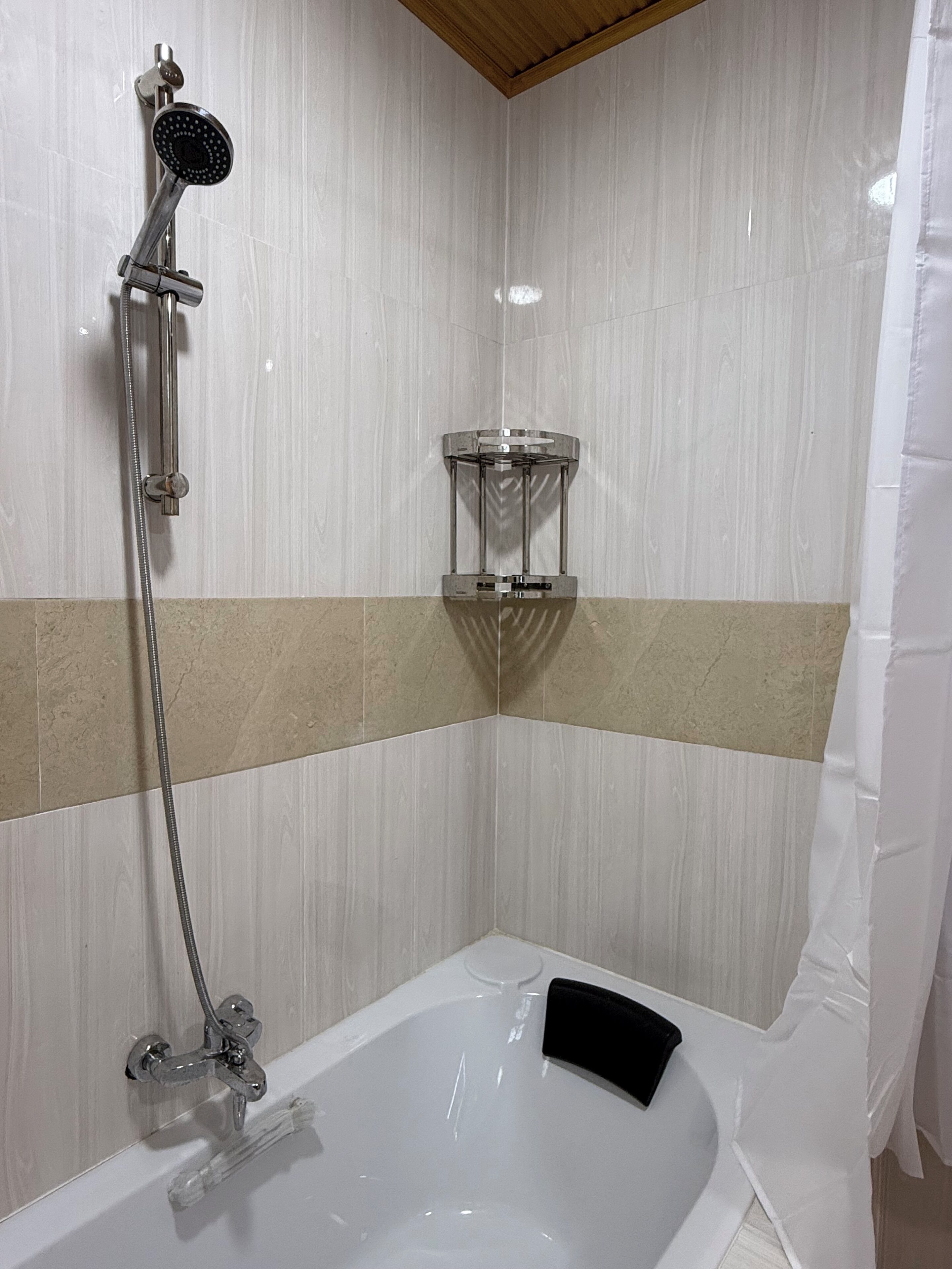 Une salle de bain équipée d’une baignoire, d’une douche et d’un porte-serviettes.