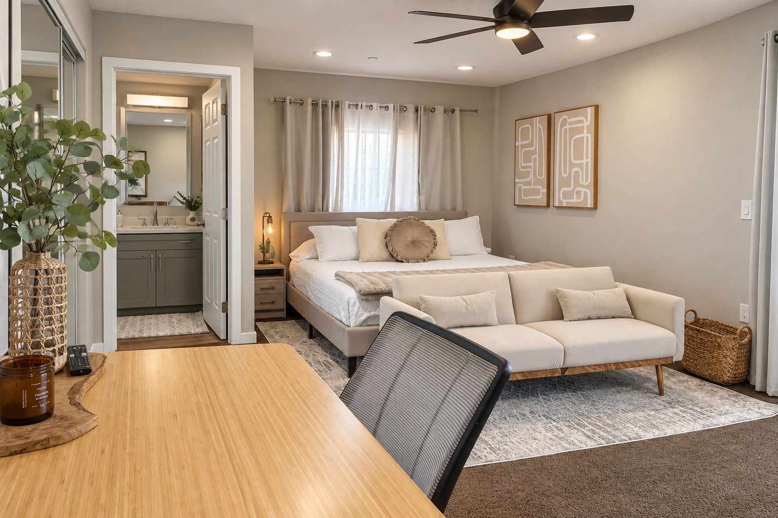 Unwind in this inviting bedroom suite featuring a plush bed, cozy loveseat, dedicated workspace, and convenient ensuite bathroom.