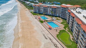 A beachfront hotel with multiple swimming pools, a beach, and a golf course. - Sandpiper 108 (New Smyrna Beach)