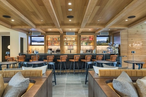 A bar area with wooden ceiling, bar stools, and a view of mountains. - Quaint 1BR/2BA Alpine Unit in Keystone Near Lifts (Keystone)