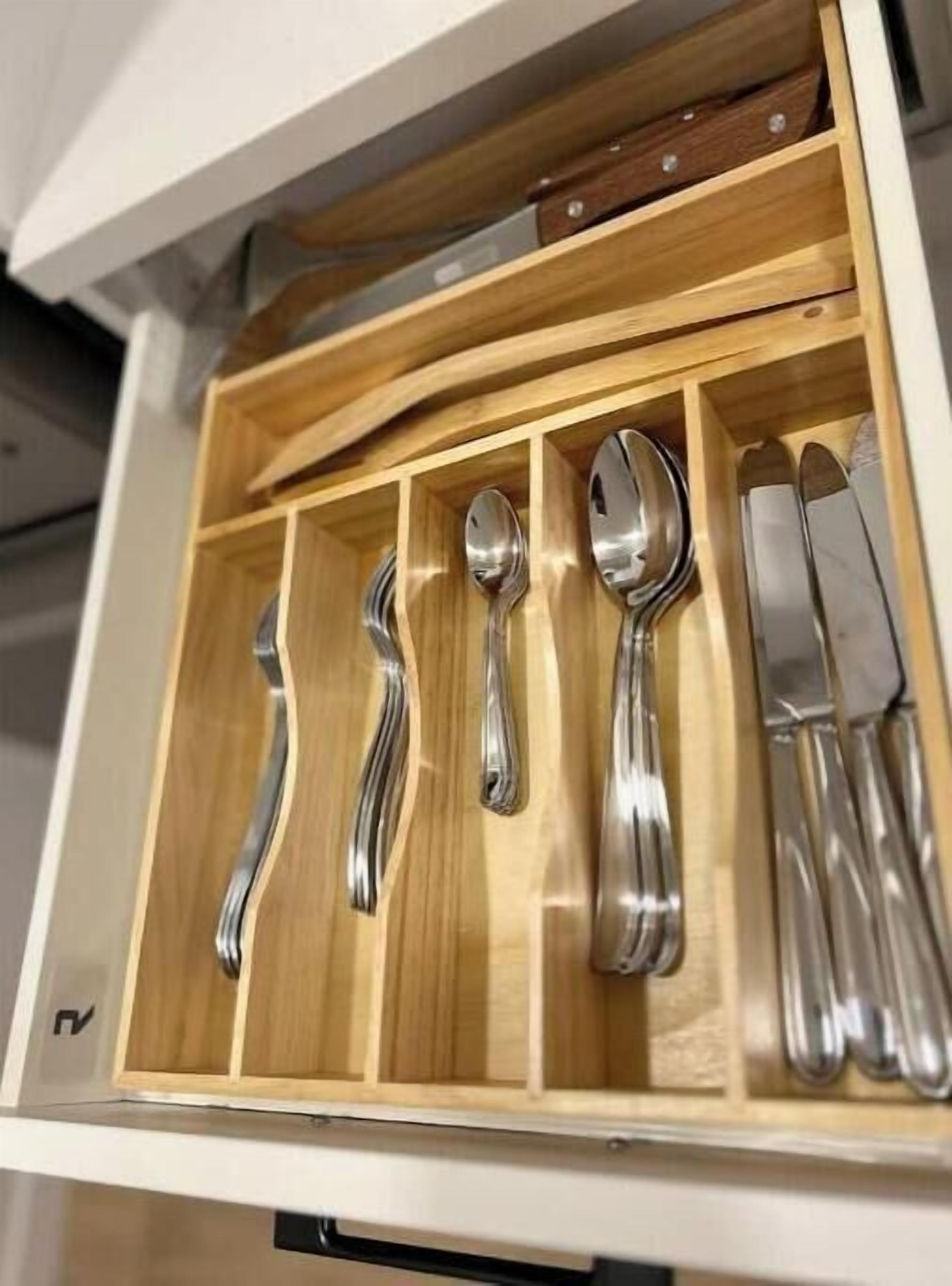 A drawer containing various silverware including forks, spoons, and knives.