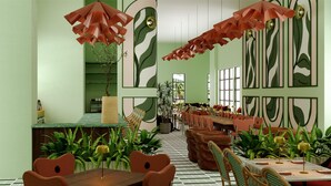 A restaurant with green walls, patterned wallpaper, and a checkered floor. Tables are set with chairs and have umbrellas above them. - Hilton Miami Beach (Miami Beach)