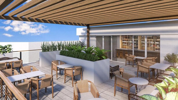 A rooftop terrace with outdoor seating, a bar area, and a view of the city skyline. - Hilton Miami Beach (Miami Beach)