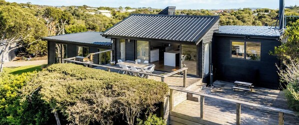 A modern house with a deck, a patio, and a view of the surrounding landscape. - Capeviews on Higgins with separate Studio (Rye)