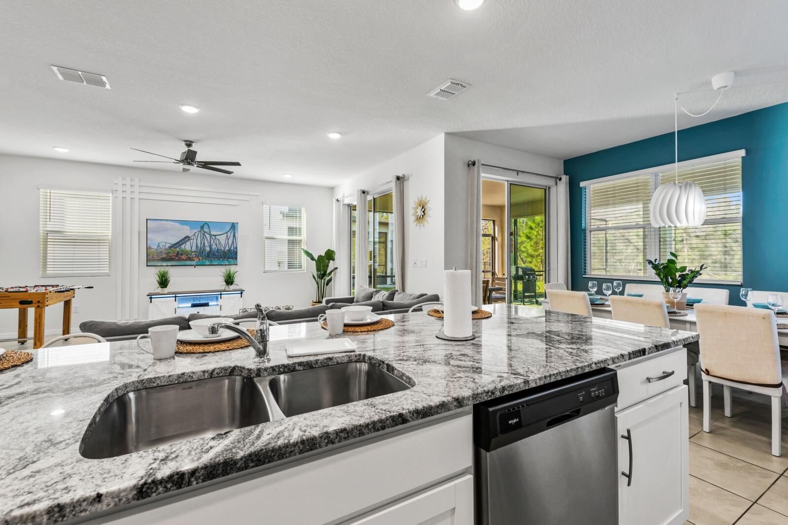 A modern kitchen with granite countertops, stainless steel appliances, and a dishwasher.