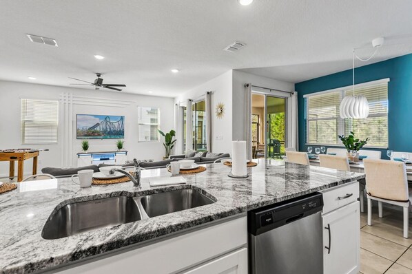 A modern kitchen with granite countertops, stainless steel appliances, and a dishwasher.