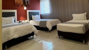 A hotel room with two beds, a cityscape painting on the wall, and a modern ceiling design. - Mirago Hotel (Yumbo)