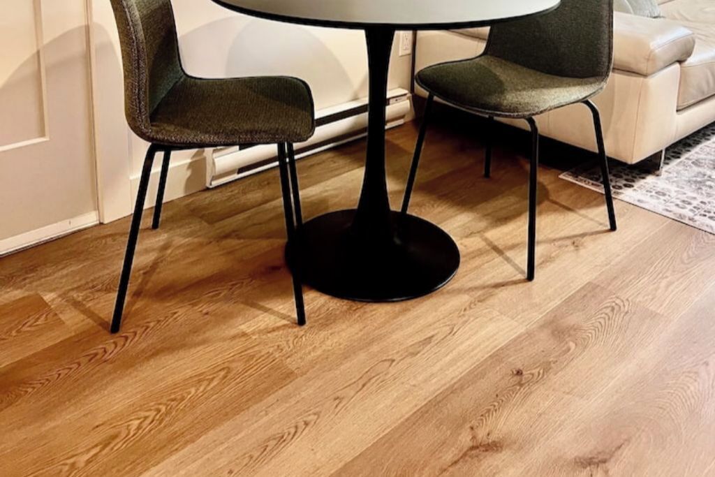 A dining area with a round table and two chairs.