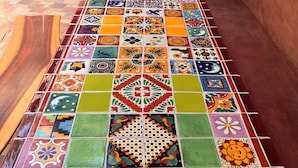 A tiled floor with a variety of colorful patterns.