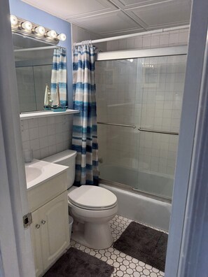 A bathroom with a toilet, sink, and shower area. - OCEAN FRONT! It doesn't get better than this! (Wildwood Crest)