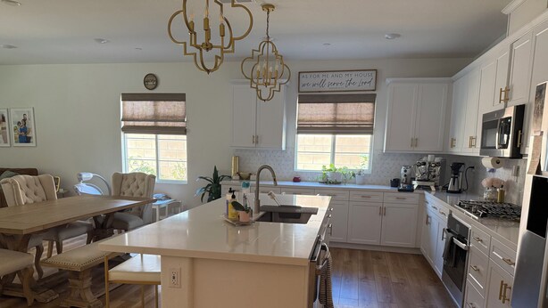 A spacious kitchen with a central island, white cabinetry, and modern appliances. - Desert Getaway Home 4 bed and 2 bath with luxurious upgrades (Palm Desert)