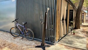A modern building with a metal exterior and a wooden fence. - TJ Escape - Mobile Home With Hot Tub And Terrace (Pakoštane)
