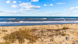 A beach with sand dunes and a clear sky.