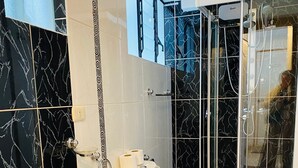 A modern bathroom with a toilet, sink, and shower area. - Relax in San Blas - 3-Bedroom Apartment with Views 🌅 (Cusco)