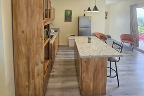 Fridge, microwave, coffee/tea maker, cookware/dishes/utensils