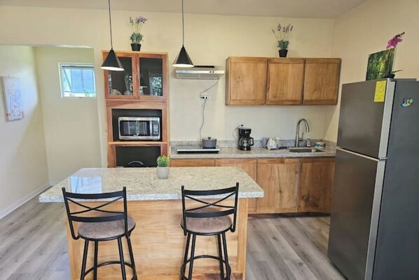 Fridge, microwave, coffee/tea maker, cookware/dishes/utensils