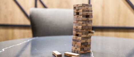 A stack of wooden blocks on a reflective surface with a blurred background.